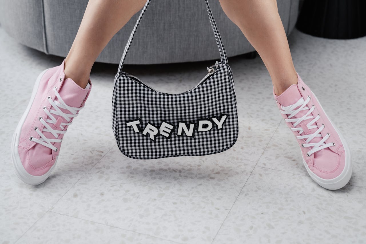 home-img Pink sneakers paired with a trendy checked bag indoors, showcasing youthful fashion.